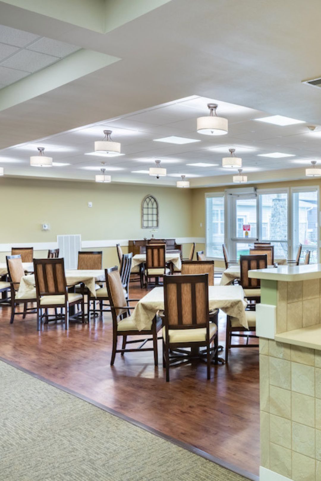 Resident enjoying a chef-prepared meal in the dining room
